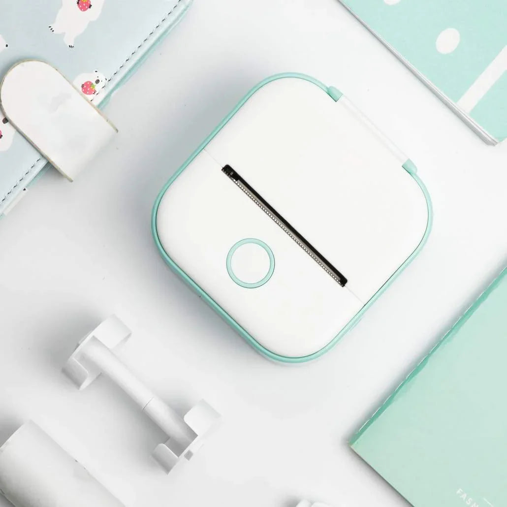 Beckett portable printer with compact design, white color, and connected cables, ready for on-the-go printing.