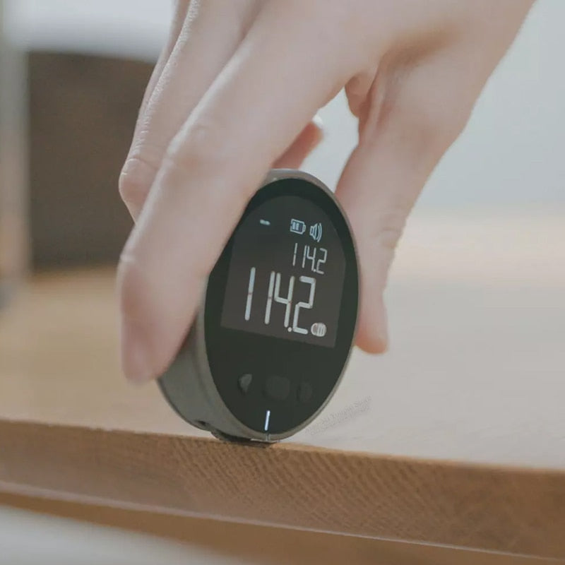 Beckett digital measurement tape displaying a clear digital readout and flexible measuring tape in a close-up shot.