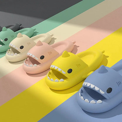 Beckett Shark slides featuring a black and white shark design, cushioned straps, and slip-on style for casual comfort.