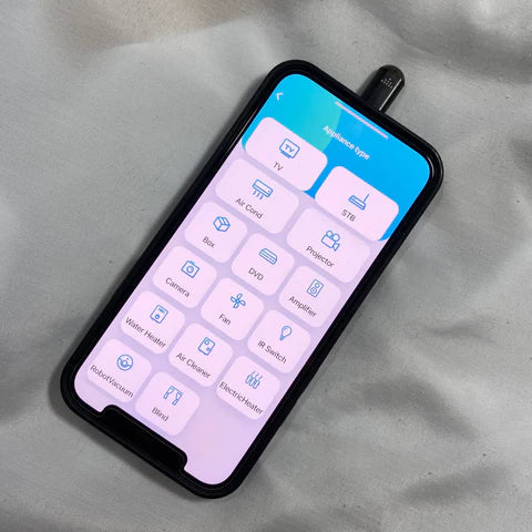 Beckett infrared phone adapter connected to smartphone, showcasing compact design for wireless device communication