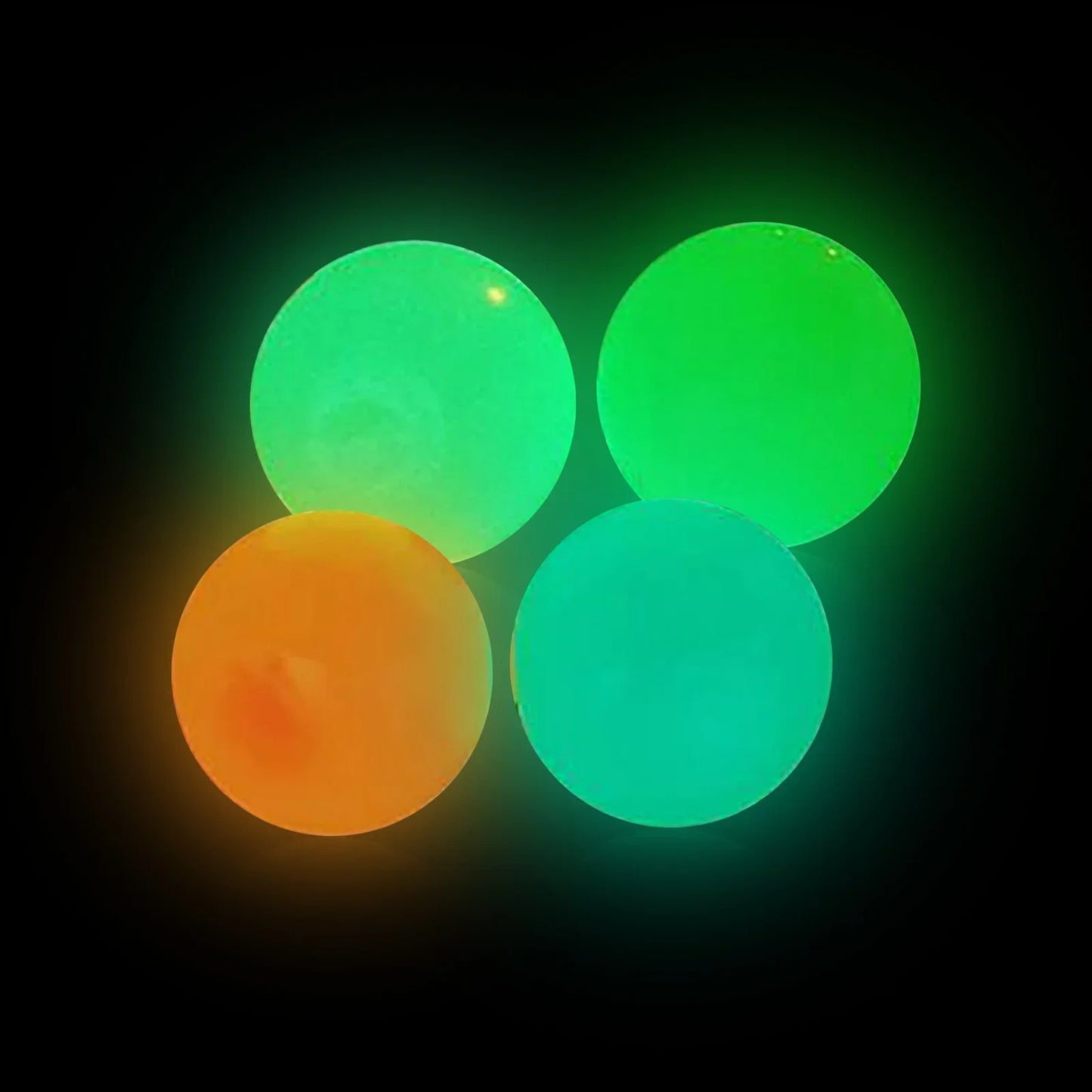 Beckett Sticky Glow Balls in vibrant colors, glowing in the dark for fun outdoor play and sensory stimulation.