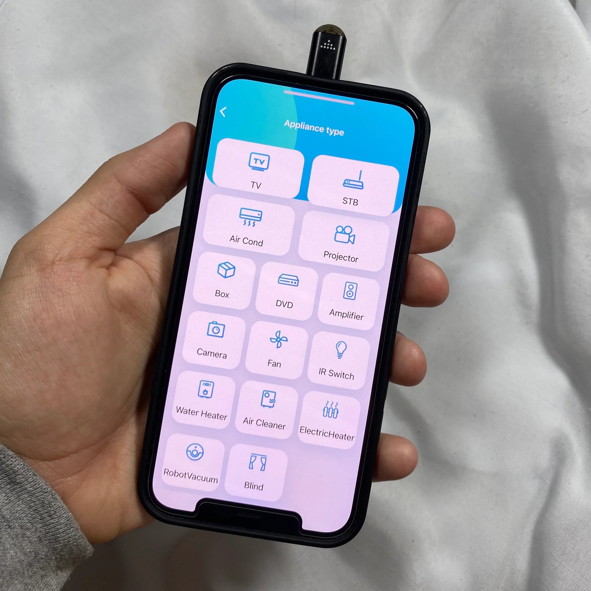 Beckett infrared phone adapter connected to a smartphone, showcasing compact design for wireless data transfer and device compatibility.