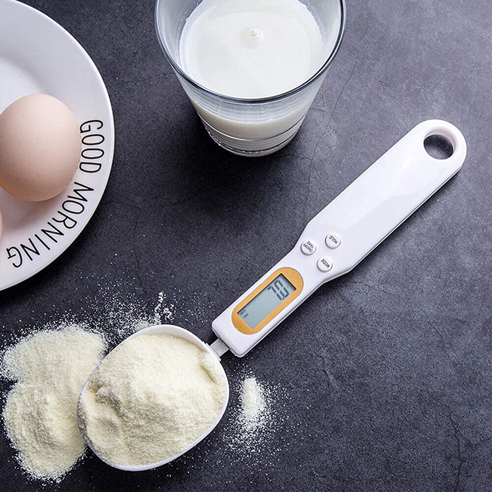 Beckett LCD digital kitchen scale with spoon, featuring a clear display and stainless steel bowl for precise food measurements.
