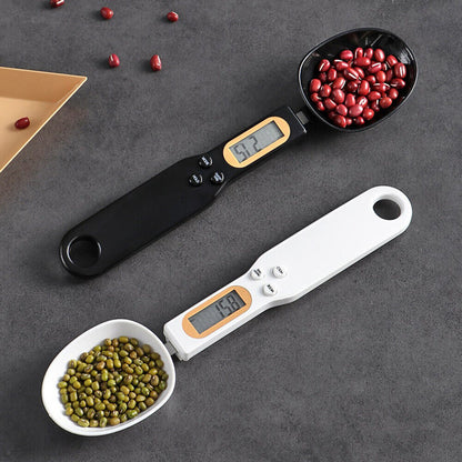 Beckett LCD digital kitchen scale with spoon, featuring a clear display and stainless steel surface for precise measurement.